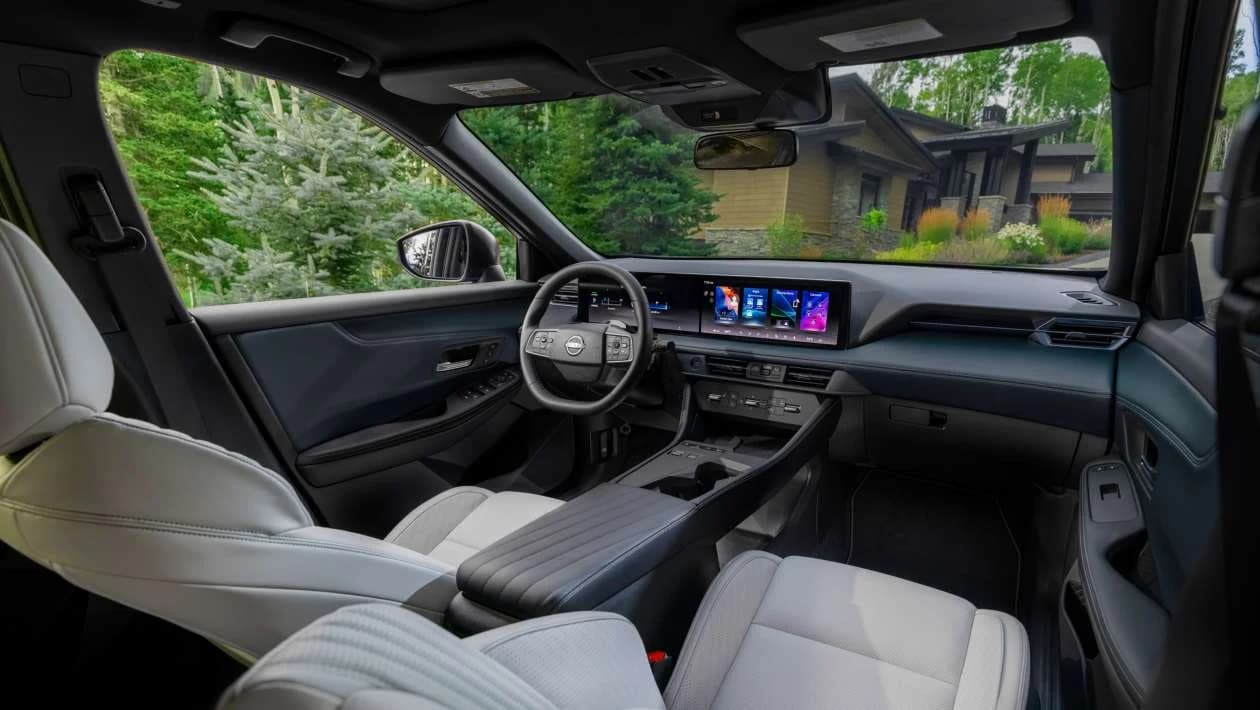 Car interior with digital displays and physical controls