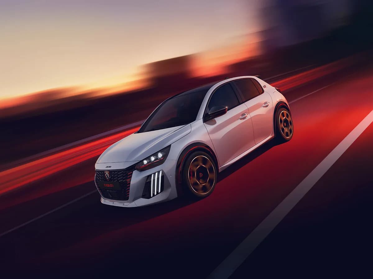 White Peugeot E-208 GTi photographed from the front while moving