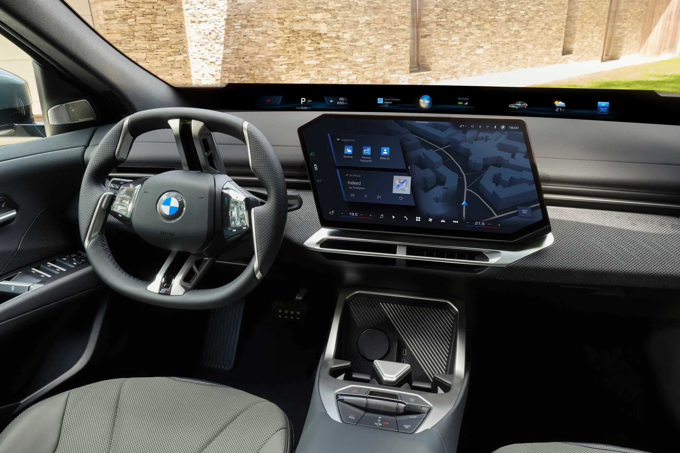 BMW iX4 interior with the steering wheel and central display