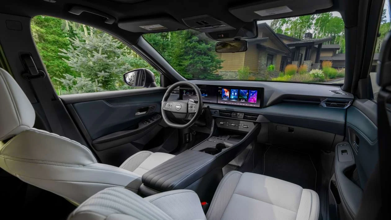 Car interior with digital displays and physical controls