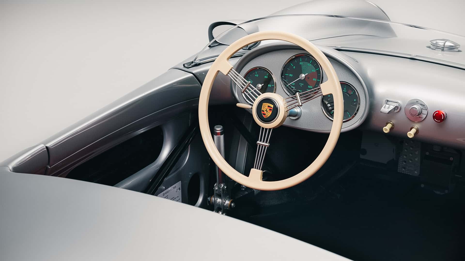 The dashboard and classic-style steering wheel of the Porsche 550 J