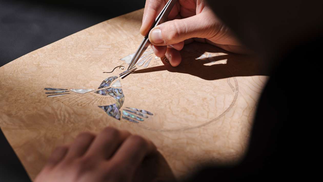 Hand-fitting the fragments that form the hummingbird motif